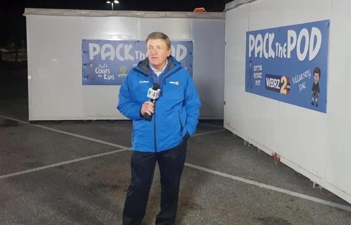 Pat Shingleton is wearing a blue jacket and reporting the news. 